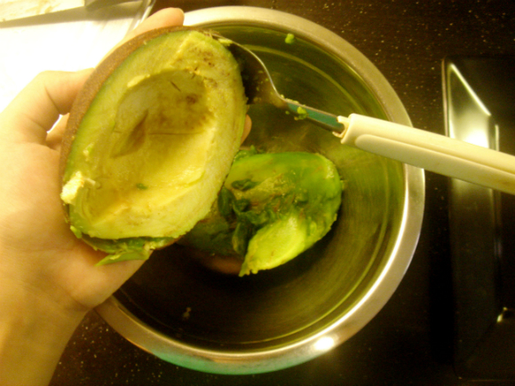 scooping out avocado